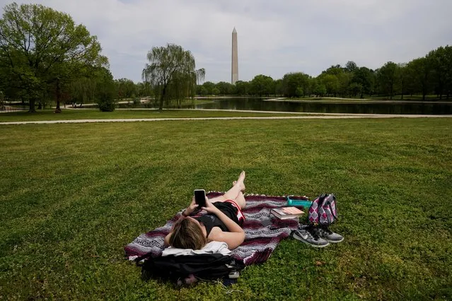 Chelsea Bruchs enjoys a nice day on the National Mall as the coronavirus disease (COVID-19) pandemic continues in Washington, U.S., April 29, 2020. (Photo by Kevin Lamarque/Reuters)