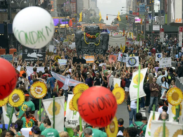 Marchers come down 6th Ave during the People's Climate March on September 21 2014, in New York. (Photo by Timothy A. Clary/AFP Photo)