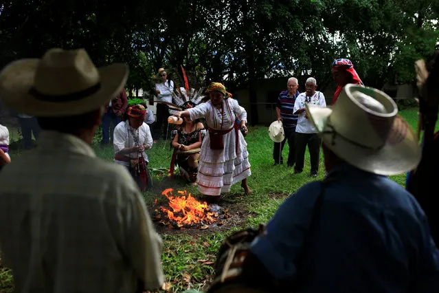 People participate in a traditional ceremony to commemorate the International Day of the World's Indigenous People in Izalco, El Salvador August 9, 2016. (Photo by Jose Cabezas/Reuters)