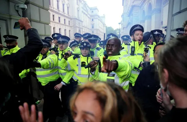 Police clash with demonstrators on Whitehall during a Black Lives Matter protest in London, following the death of George Floyd who died in police custody in Minneapolis, London, Britain, June 7, 2020. (Photo by Hannah McKay/Reuters)