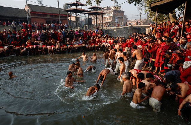 Devotees take holy dip at the Hanumante River during the final day of the month-long Swasthani Brata Katha festival in Bhaktapur, Nepal on February 12, 2025. (Photo by Navesh Chitrakar/Reuters)