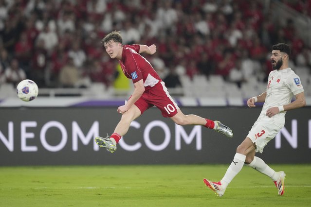 Indonesia's Ole Lennard Romenij, left, shoots past Bahrain's Waleed Alhayam during a World Cup 2026 group C Asia qualifying soccer match between Indonesia and Bahrain at Gelora Bung Karno Main Stadium in Jakarta, Indonesia, Tuesday, March 25, 2025. (Photo by Tatan Syuflana/AP Photo)