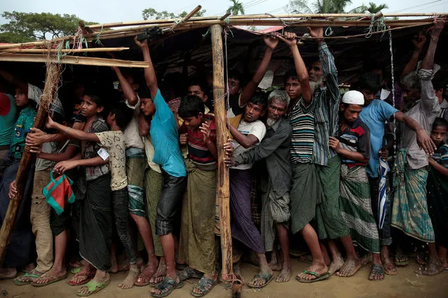 Rohingya refugees jostle as they line up for a blanket distribution under heavy rainfall at the Balukhali camp near Cox's Bazar, Bangladesh December 11, 2017. (Photo by Alkis Konstantinidis/Reuters)