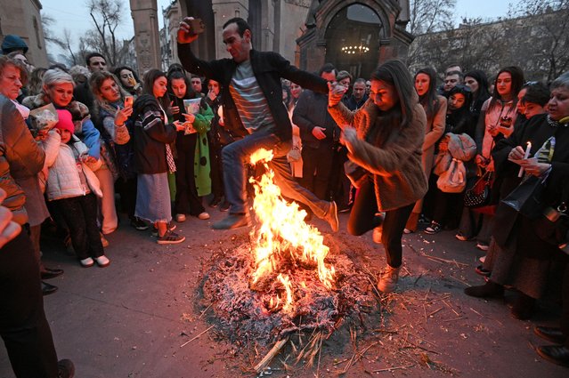 Christian Armenians celebrate Trndez, a feast of purification, in front of St. Anna Church in Yerevan on February 13, 2024. Trndez, now celebrated as a Christian feast, has pagan origins and in ancient pre-Christian Armenia was associated with the worship of Vahagn, the god of Fire and Sun, and celebrated as nature awakening festival. Couples, especially newlyweds, jump over the Trndez bonfire believing it will bring luck and prosperity to them. (Photo by Karen Minasyan/AFP Photo)