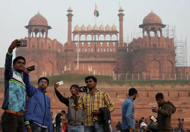 Domestic tourists take selfies in front of the historic Red Fort, one of the tourist destinations in the old quarters of Delhi, India, January 3, 2018. (Photo by Saumya Khandelwal/Reuters)