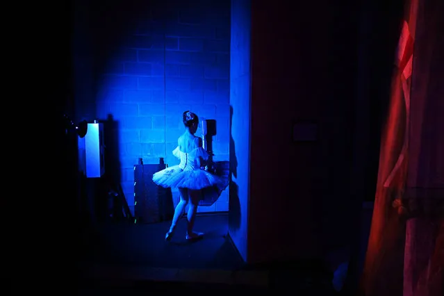 A dancer is illuminated backstage during a Manassas Ballet Theatre presentation of the Nutcracker at the Hilton Performing Arts Center on Sunday December 18, 2022 in Manassas, VA. The production featured dancers from ten countries, including those from the United States. (Photo by Matt McClain/The Washington Post)