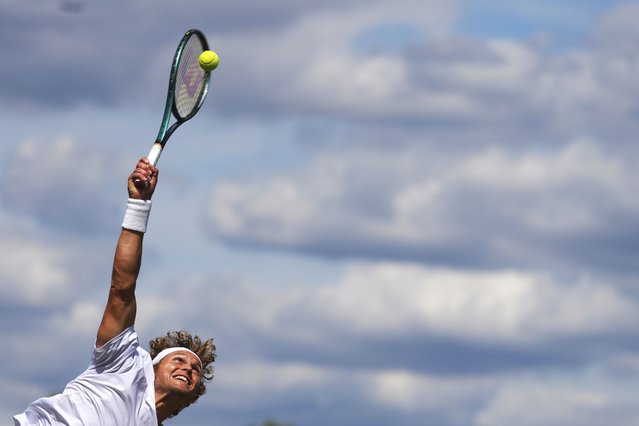 August Holmgren of Denmark serves to Tomas  Machac of Czech Republic during their second round men's singles match at the Wimbledon Tennis Championships in London, Thursday, July 3, 2025. (Photo by Kirsty Wigglesworth/AP Photo)