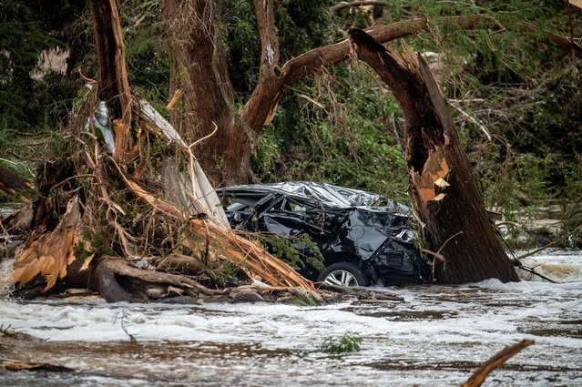 A car is caught between trees in the Guadalupe River after deadly flooding in Kerr County, Texas, on July 5, 2025. (Photo by Sergio Flores/Reuters)