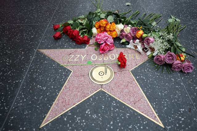 Flowers are left at Ozzy Osbourne's Star on the Hollywood Walk of Fame on July 22, 2025, in Los Angeles. Osbourne, the legendary frontman of heavy metal group Black Sabbath, died on Tuesday at the age of 76, his family announced in a statement. “He was with his family and surrounded by love. We ask everyone to respect our family privacy at this time”, the statement said. (Photo by Patrick T. Fallon/AFP Photo)