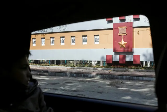 A boy is seen in a car driving past a Soviet-style billboard honouring prominent local citizens in Kharkiv, Ukraine September 24, 2016. (Photo by Gleb Garanich/Reuters)