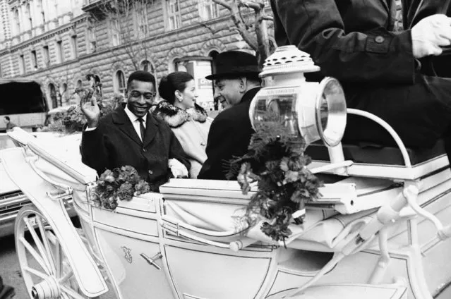 Brazilian soccer star Pele waves to admirers, as he and his bride Rosemeri ride in a traditional horse-drawn carriage as they tour Salzburg, Austria, February 25, 1966. Pelé, the Brazilian king of soccer who won a record three World Cups and became one of the most commanding sports figures of the last century, died in Sao Paulo on Thursday, Dec. 29, 2022. He was 82. (Photo by Klaus Frings/AP Photo/File)