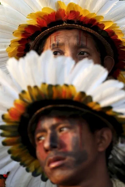 Indigenous men from the Erikbaktsa tribe watch a presentation of the various sporting disciplines included in the first World Games for Indigenous Peoples in Palmas, Brazil, October 24, 2015. (Photo by Ueslei Marcelino/Reuters)