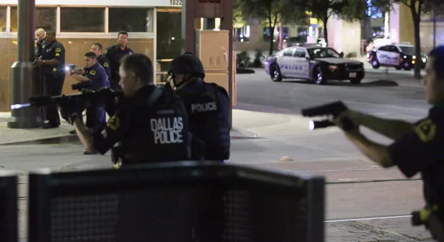 In this July 7, 2016, file photo, Dallas police move to detain a driver after several police officers were shot in downtown Dallas when a sniper opened fire at a Black Lives Matter protest. A grand jury on Wednesday, January 31, 2018, declined to bring charges against Dallas police officers responsible for the death of the sniper. (Photo by L.M. Otero/AP Photo)