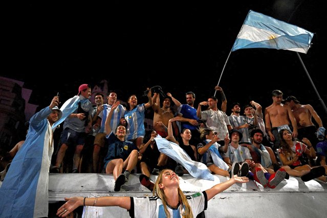 Fans of Argentina celebrate at the Obelisk after winning the Qatar 2022 World Cup against France in Buenos Aires on December 18, 2022. (Photo by Luis Robayo/AFP Photo)