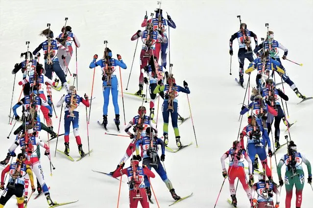 Lisa Vittozzi, of Italy, centre right, skis at the start of the Single Mixed Relay event at the Biathlon World Championships in Oberhof, Germany, Thursday, February 16, 2023. (Photo by Matthias Schrader/AP Photo)