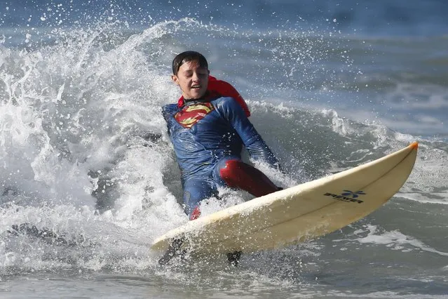 Catello Dannunzio, 14, surfs as Superman during the ZJ Boarding House Haunted Heats Halloween Surf Contest in Santa Monica, California, United States, October 31, 2015. (Photo by Lucy Nicholson/Reuters)