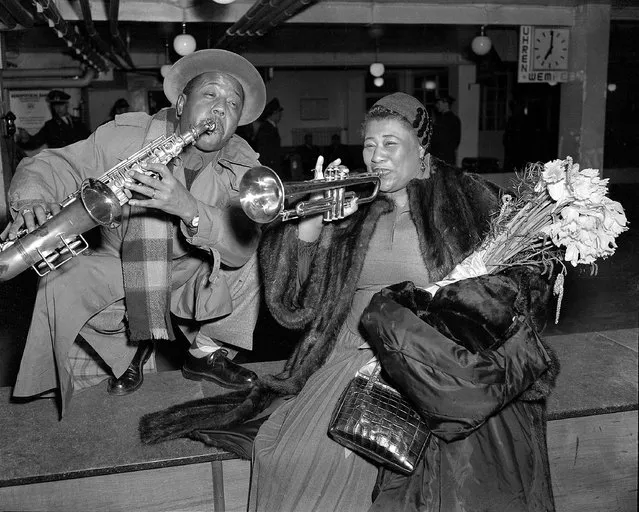 Jazz vocalist Ella Fitzgerald and trumpeter Roy Eldridge pose for photographers after arriving at the airport in Hamburg, West Germany on February 15, 1954 for a tour of Germany with other top jazz figures.  They were scheduled to appear before German audiences on promoter/producer Norman Grayz'  “Jazz at the Philharmonic”. (Photo by AP Photo/Brueggeman)