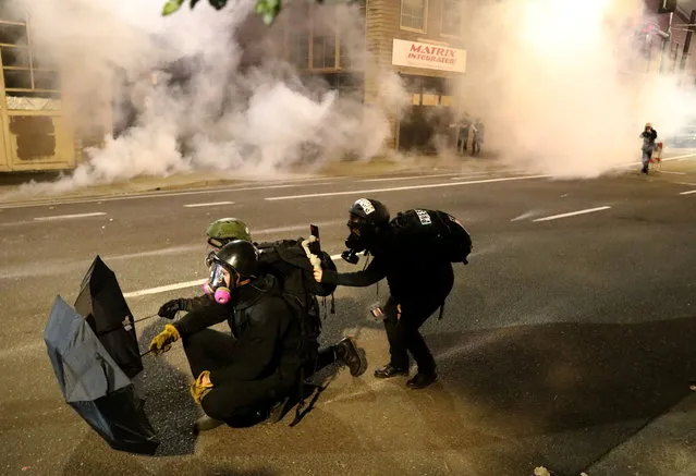 Demonstrators clash with Federal and Portland police at an Immigration and Customs Enforcement facility in Portland, Oregon, U.S. October 29, 2020. (Photo by Goran Tomasevic/Reuters)