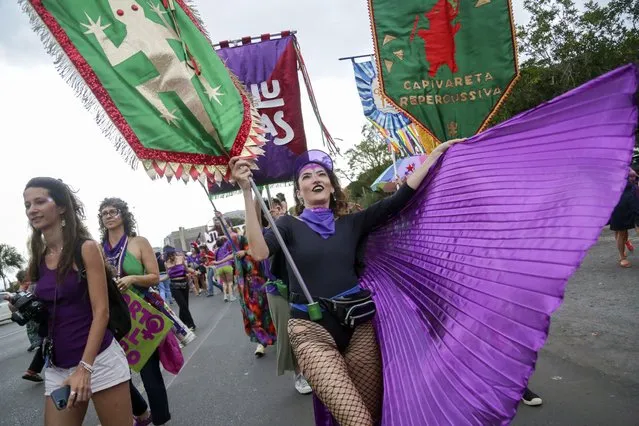 Women take part in a march marking International Women's Day, in Brasilia, Brazil, Wednesday, March 8, 2022. (Photo by Gustavo Moreno/AP Photo)