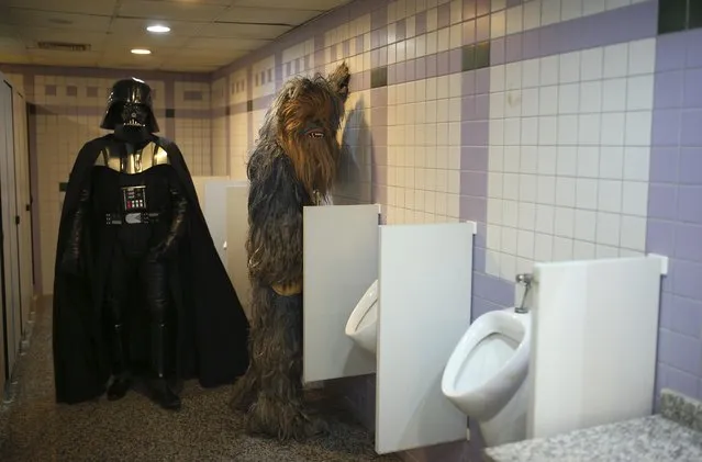 Fans dressed as Dark Vader, left, and Chewbacca are pictured in a bathroom as they attend 53rd Antalya Film Festival in Mediterranean Turkish resort of Antalya, Turkey, Monday, October 17, 2016. (Photo by Emre Tazegul/AP Photo)