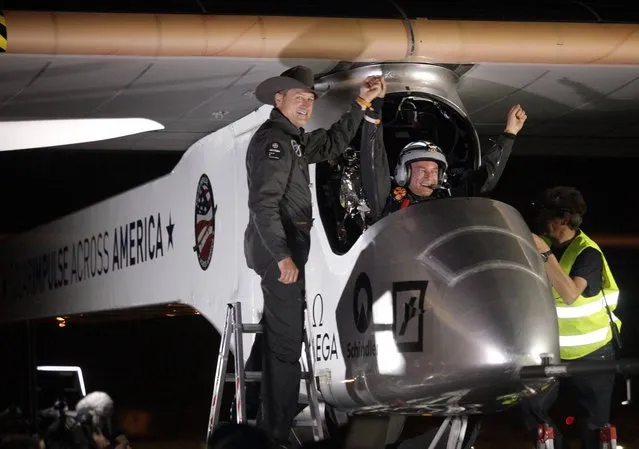 Solar Impulse co-founder, pilot and CEO Andre Borschberg, left, greets pilot Bertrand Piccard at Sky Harbor International Airport in Phoenix, early Saturday, May 4, 2013, after completing the first leg of its coast-to-coast flights across the United States. It is the first time that a solar airplane capable of flying day and night without fuel, will attempt to fly across America. Solar Impulse began its journey Friday in San Francisco in its attempt to reach New York. (Photo by AP Photo/Scuteri)
