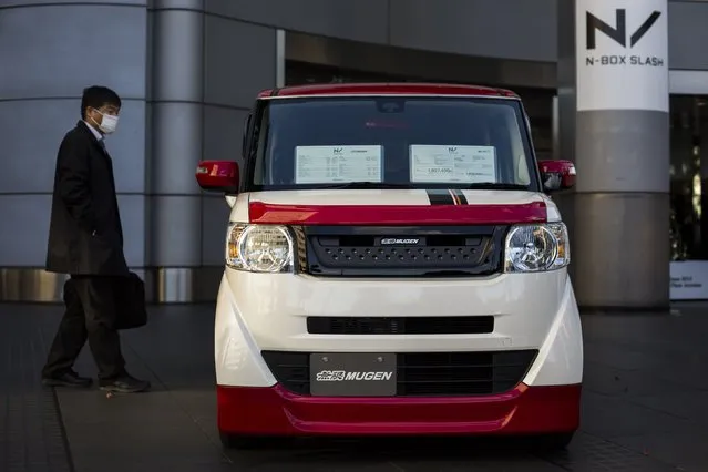 Man looks at the new Honda N-Box Slash during its presentation outside the carmaker's headquarters in Tokyo December 22, 2014. (Photo by Thomas Peter/Reuters)