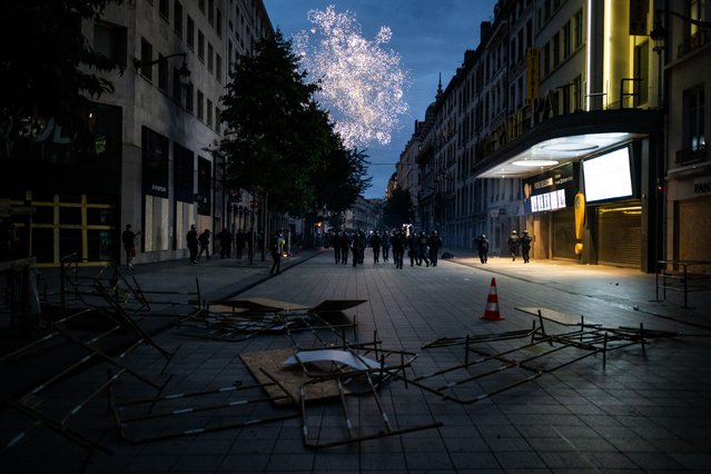 Anti-riot policemen run after demonstrators who use fireworks during a rally after the announcement of the results of the first round of parliamentary elections in Lyon, eastern France, on June 30, 2024. France's far right won the first round of pivotal legislative elections on June 30, 2024, with the centrist forces of France's President coming in only third behind the left after the highest turnout in over four decades, estimates said. (Photo by Jeff Pachoud/AFP Photo)