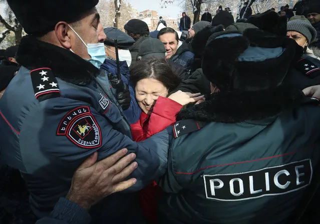 Demonstrators scuffle with Armenian police during a rally to pressure Armenian Prime Minister Nikol Pashinyan to resign over a peace deal with neighboring Azerbaijan on Republic Square in Yerevan, Armenia, Thursday, December 24, 2020. (Photo by Vahram Baghdasaryan, Photolure via AP Photo)
