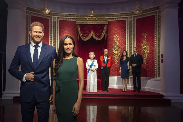 The figures of Britain's Prince Harry and Meghan, Duchess of Sussex, left, are moved from their original positions next to Queen Elizabeth II, Prince Philip and Prince William and Kate, Duchess of Cambridge, at Madame Tussauds in London, Thursday January 9, 2020. Madame Tussauds moved its figures of Prince Harry and Meghan, Duchess of Sussex from its Royal Family set to elsewhere in the attraction. (Photo by Victoria Jones/PA Wire via AP Photo)