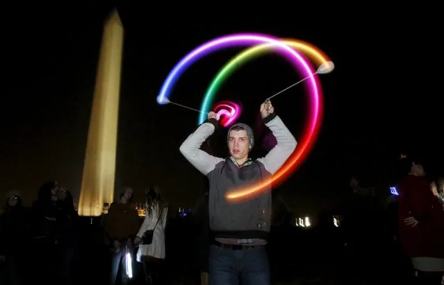 Ross Vidal spins a pair of LED "glow poi" in front of the Washington Monument during a 48-hour vigil called "Catharsis on the Mall: A Vigil for Healing the Drug War" on the U.S. National Mall in Washington November 21, 2015. (Photo by Jim Bourg/Reuters)