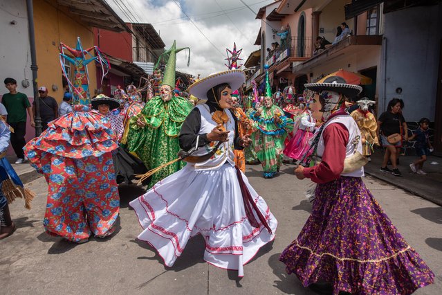 Traditional dancers perform during the Santa Maria Magdalena Patron Feast on July 20, 2024 in Xico, Mexico. As every year, thousands of people visit Xico to celebrate the town patron saint, Santa Maria Magdalena. The event offers many cultural and religious activities, the streets are decorated with sawdust carpets, many groups perform dances and people gather to take part in different processions. (Photo by Hector Quintanar/Getty Images)