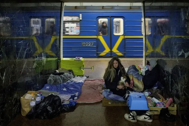 People shelter from possible air raids in a metro station as Russia's attack on Ukraine continues, in Kyiv, Ukraine, March 8, 2022. (Photo by Thomas Peter/Reuters)