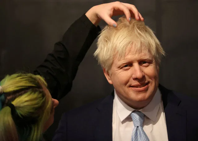 Emma Meehan, a waxworks artist adds finishing touches to the Boris Johnson waxwork figure during the unveiling at Madame Tussauds in Blackpool, Britain March 22, 2022. (Photo by Molly Darlington/Reuters)