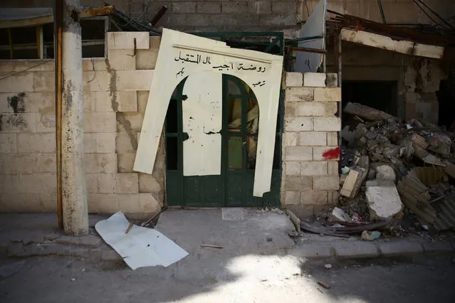 The damaged entrance to a kindergarten is pictured after an air strike in the rebel-held besieged city of Harasta, in the eastern Damascus suburb of Ghouta, Syria November 6, 2016. The text on the arch reads in Arabic, “Future generations kindergarten, welcomes you”. (Photo by Bassam Khabieh/Reuters)