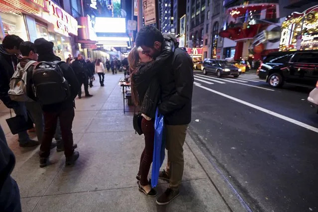 A man and a woman kiss in Times Square in the Manhattan borough of New York November 25, 2015. (Photo by Carlo Allegri/Reuters)