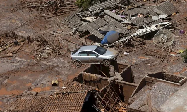Debris is pictured in Bento Rodigues district which was covered with mud after a dam owned by Vale SA and BHP Billiton Ltd burst, in Mariana, Brazil, November 10, 2015. (Photo by Ricardo Moraes/Reuters)