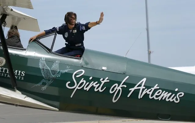 British aviator Tracey Curtis-Taylor celebrates her arrival at Sydney's International Airport in an open cockpit biplane, January 9. 2016. (Photo by Jason Reed/Reuters)