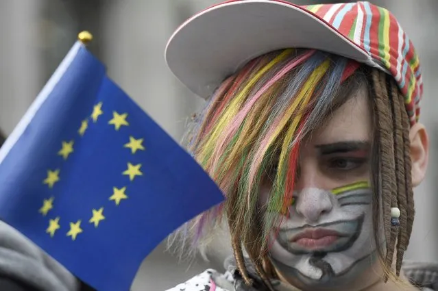 A protester holds a European Union flag outside the Supreme Court on the first day of the challenge against a court ruling that Theresa May's government requires parliamentary approval to start the process of leaving the European Union, in Parliament Square, central London, Britain December 5, 2016. (Photo by Toby Melville/Reuters)