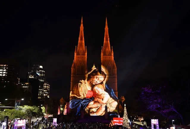 St Mary's Cathedral is illuminated with a Christmas-themed projection in Sydney to celebrate the Christmas season on December 9, 2016. (Photo by Saeed Khan/AFP Photo)