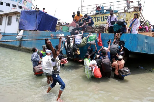 Amid a mad rush of holidaymakers, ferry services on busy Paturia-Daulatdia and Shimulia-Banglabazar routes were suspended on Saturday morning – leaving thousands of people stranded on both sides of Padma River in Dhaka on May 8, 2021. The sudden suspension caused immense sufferings to people on their way to their village homes ahead of the Eid-ul-Fitr holidays, violating government directives against inter-district travel. (Photo by Habibur Rahman/ZUMA Wire/Rex Features/Shutterstock)