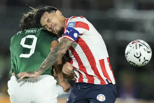 Bolivia's Marcelo Moreno, left, fights for the ball with Paraguay's Gustavo Gomez during a qualifying soccer match for the FIFA World Cup 2026, at Defensores del Chaco Stadium in Asuncion, Paraguay, Tuesday, October 17, 2023. (Photo by Jorge Saenz/AP Photo)