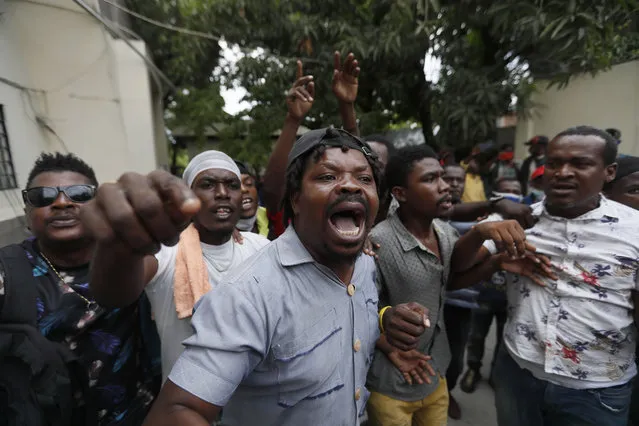 Supporters of former Senator Steven Benoit shout outside the courthouse as he departs after being called in for questioning, in Port-au-Prince, Monday, July 12, 2021. (Photo by Fernando Llano/AP Photo)