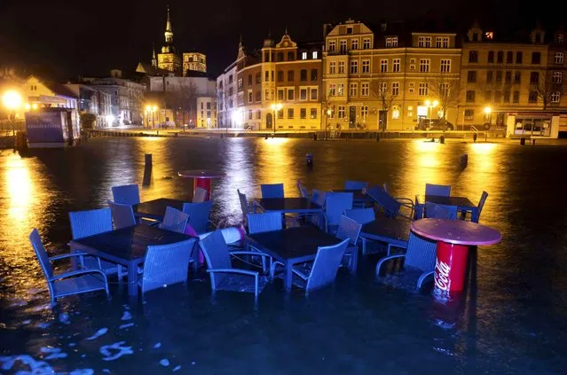 Furniture of a restaurant are surrounded by flood water in the harbor of Stralsund, northern Germany, Thursday morning, January 5, 2017 after the northern German coast region was hit by high tide. (Photo by Stefan Sauer/DPA via AP Photo)