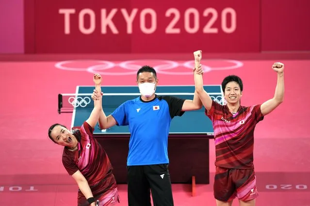 Japan's Mima Ito, left, and Jun Mizutani celebrate after winning the table tennis mixed doubles gold medal match against China's Xu Xin and Liu Shiwen at the 2020 Summer Olympics, Monday, July 26, 2021, in Tokyo. (Photo by Kin Cheung/AP Photo)