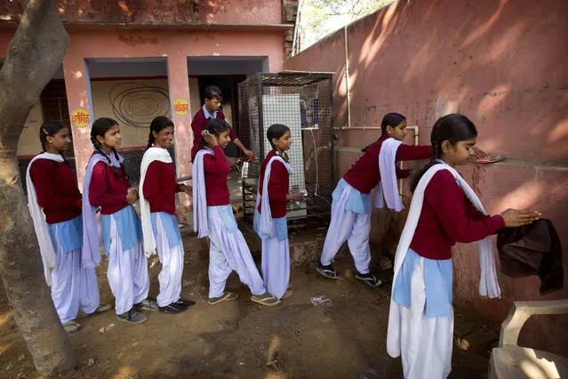 School children line up to wash their hands before taking deworming pill at a school in Neemrana, 123 kilometers (76.8 miles) from New Delhi, in the Indian state of Rajsthan Wednesday, February 10, 2016. Millions of Indian children are taking part in a massive national deworming campaign to prevent parasitic worms from infecting their bodies and impairing their mental and physical development. The campaign is targeting 270 million children across the country with a second treatment planned next week for those left out on Wednesday, India’s Health Ministry said in a statement. (Photo by Manish Swarup/AP Photo)