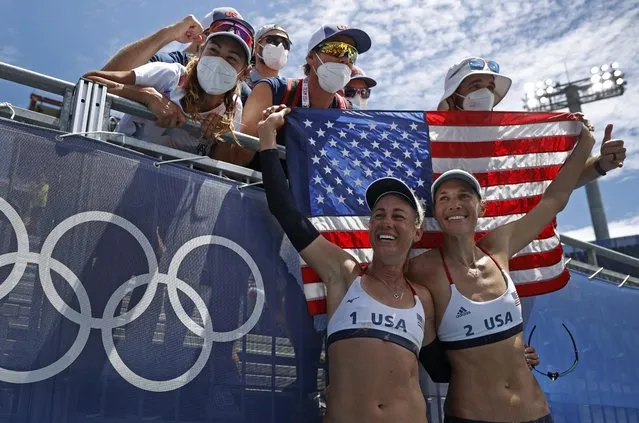 USA's April Ross (L) and Alix Klineman celebrate winning their women's beach volleyball final match between Australia and the USA during the Tokyo 2020 Olympic Games at Shiokaze Park in Tokyo on August 6, 2021. (Photo by John Sibley/Reuters)