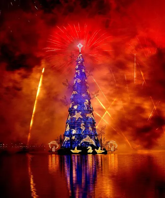 Fireworks explode over a floating Christmas tree in Lagoa Lake in Rio de Janeiro. (Photo by Victor R. Caivano/Associated Press)
