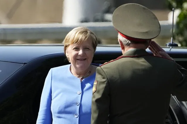 German Chancellor Angela Merkel, left, arrives for a wreath laying ceremony at the Tomb of Unknown Soldier in Moscow, Russia, Friday, August 20, 2021, prior to talks with Russian President Vladimir Putin. The talks between Merkel and Putin are expected to focus on Afghanistan, the Ukrainian crisis and the situation in Belarus among other issues. (Photo by Alexander Zemlianichenko/Pool via AP Photo)