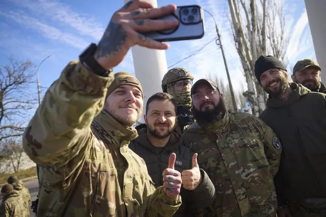 In this photo provided by the Ukrainian Presidential Press Office and posted on Facebook, Ukrainian soldiers take a selfie with President Volodymyr Zelenskyy, centre, during his visit to Kherson, Ukraine, Monday, November 14, 2022. Ukraine's retaking of Kherson was a significant setback for the Kremlin and it came some six weeks after Russian President Vladimir Putin annexed the Kherson region and three other provinces in southern and eastern Ukraine – in breach of international law – and declared them Russian territory. (Photo by Ukrainian Presidential Press Office via AP Photo)
