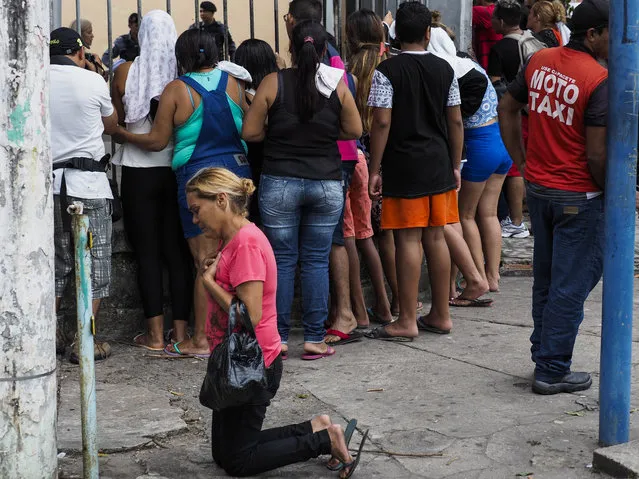 A relative of an inmate of the Desembargador Raimundo Vidal Pessoa Public Jail kneels to give thanks after finding out her loved one is not among those killed during a riot on January 8, 2017 in Manaus, Amazonas state, Brazil. At least four inmates were killed in a facility in Manaus, the capital of Amazonas state, sending the number of violent prison fatalities to over 100 in just one week. Deadly prison riots have intensified in Brazil since a truce broke down in July between the country' s two largest drug gangs, the First Capital Command (PCC) and the Red Command (CV). (Photo by Raphael Alves/AFP Photo)
